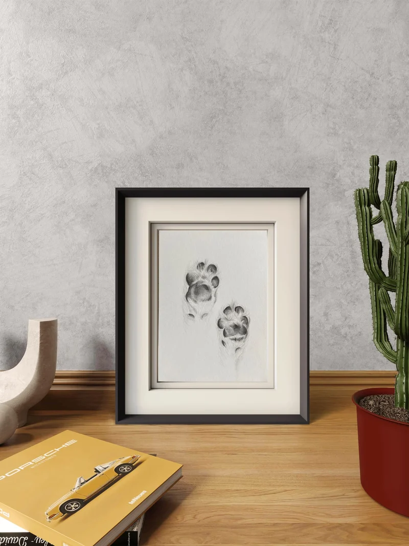 Graphite pencil drawing of two dog paw prints